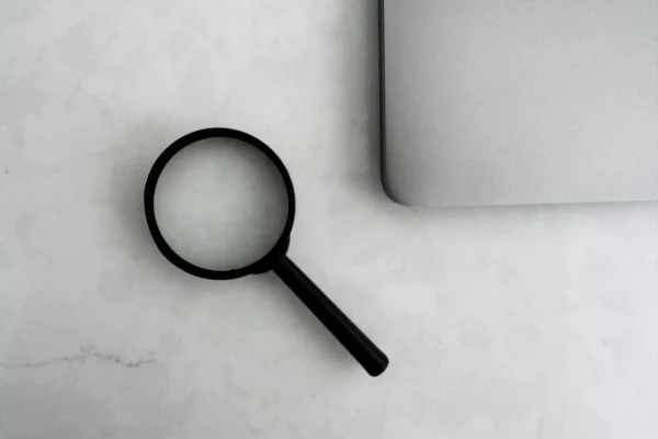 Magnifier on desk next to a laptop